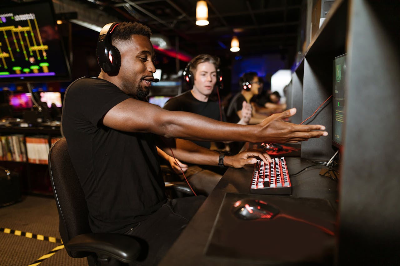 Men enjoying a multiplayer gaming session in an arcade, focused on e-sports and camaraderie.
